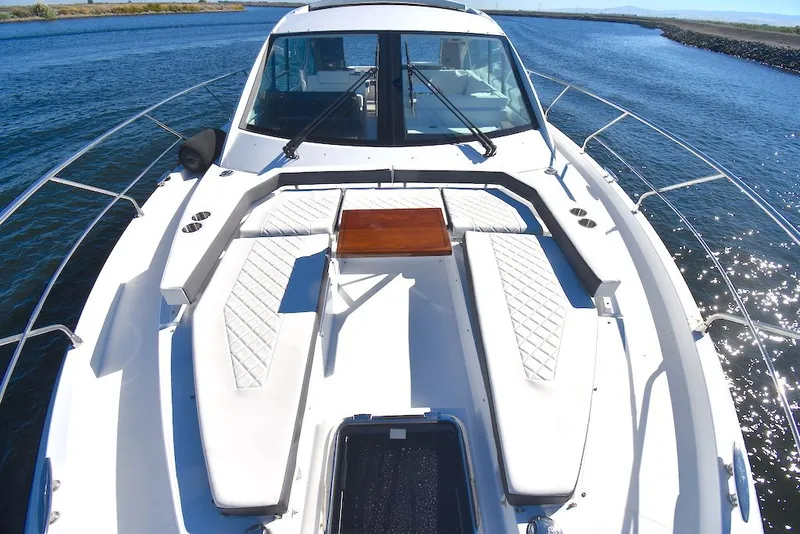 Slide: The Image of The image shows the foredeck of a 2019 Cruisers Yachts 50 Cantius with white cushions. - 43