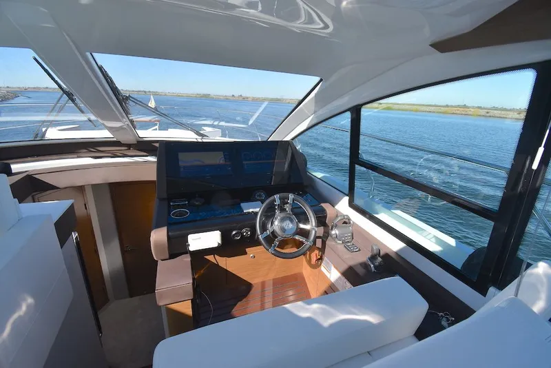 Slide: The Image of The 2019 Cruisers Yachts 50 Cantius cockpit features modern instruments and a panoramic view of the water. - 15