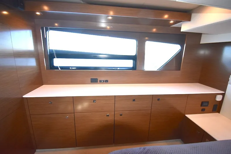 Slide: The Image of Interior of a 2019 Cruisers Yachts 50 Cantius with wood paneling and large windows. - 35