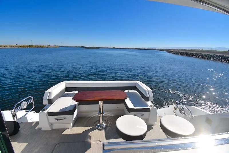 Slide: The Image of The image shows the stern of a 2019 Cruisers Yachts 50 Cantius with seating and a table. - 8