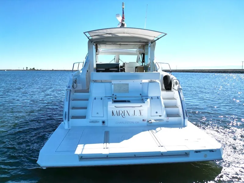 Slide: The Image of Rear view of a 2019 Cruisers Yachts 50 Cantius on the water with an open cockpit. - 6