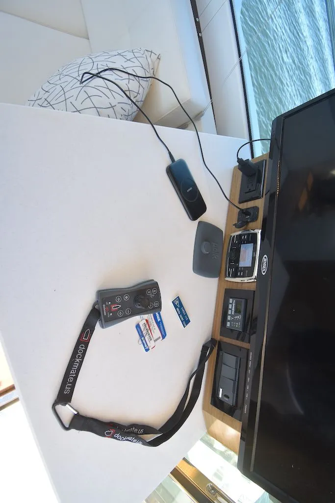 Slide: The Image of Interior view of a yacht with a table holding electronic devices and cables. - 14
