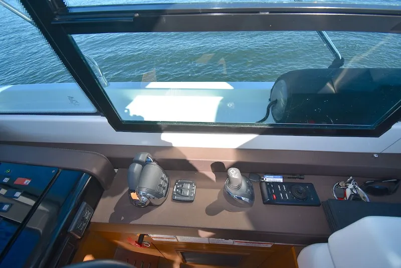 Slide: The Image of The cockpit of the 2019 Cruisers Yachts 50 Cantius features controls and instruments. - 16