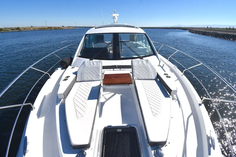 Slide: The Image of The image shows the foredeck of a 2019 Cruisers Yachts 50 Cantius with white cushions. - 44