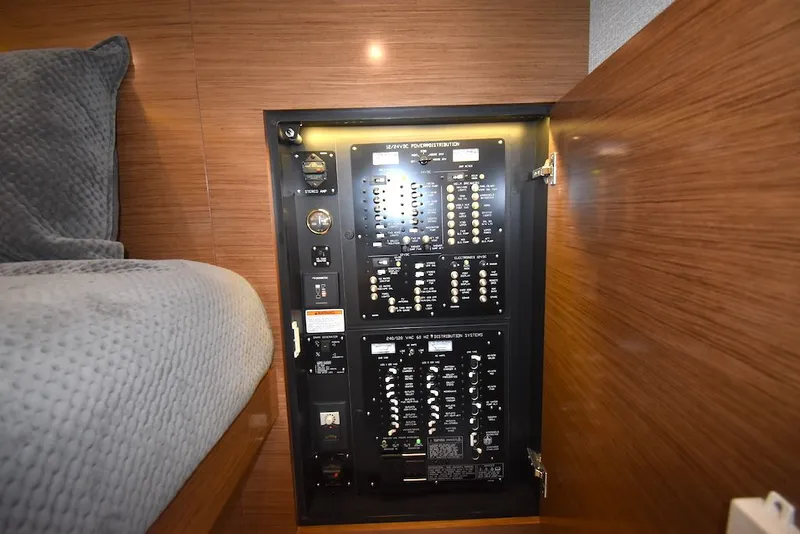 Slide: The Image of Electrical panel in a yacht cabin with wooden walls and gray bedding. - 23