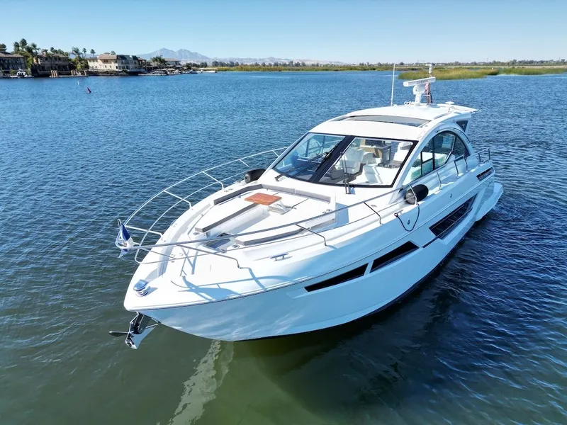 Slide: The Image of 2019 Cruisers Yachts 50 Cantius on calm water with sleek design and spacious deck. - 3