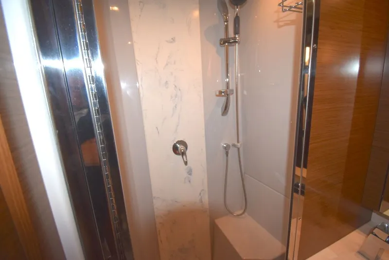 Slide: The Image of The shower in the 2019 Cruisers Yachts 50 Cantius features modern fixtures and marble accents. - 31