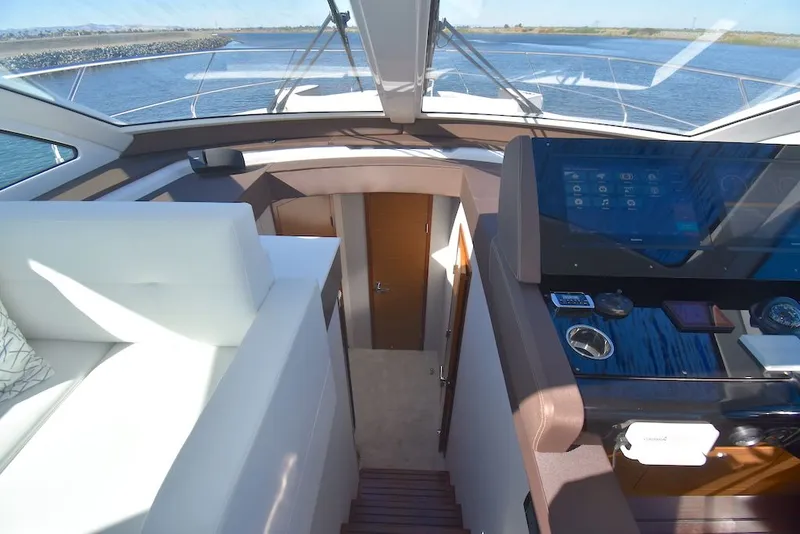 Slide: The Image of Interior of the 2019 Cruisers Yachts 50 Cantius with modern cockpit and stairs to cabin. - 22