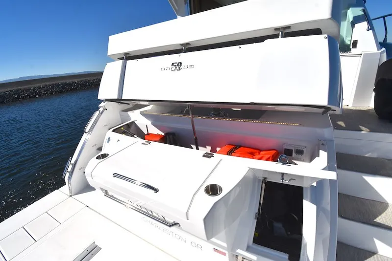 Slide: The Image of The image shows the stern of a 2019 Cruisers Yachts 50 Cantius with storage and life jackets. - 48