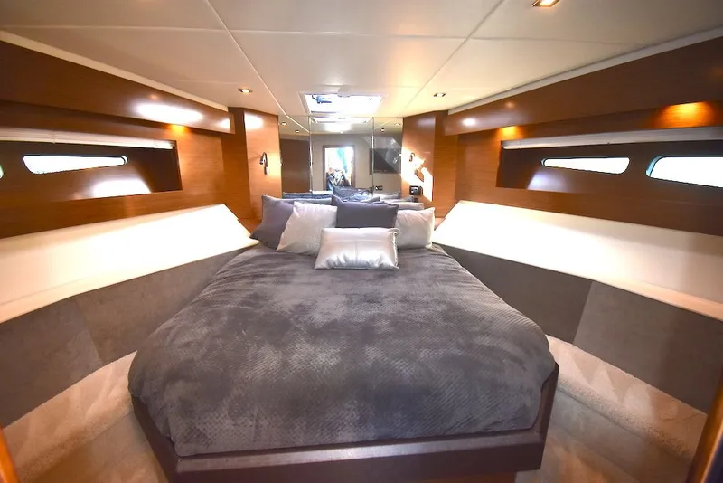 Slide: The Image of The luxurious cabin of the 2019 Cruisers Yachts 50 Cantius features a large bed and elegant lighting. - 24