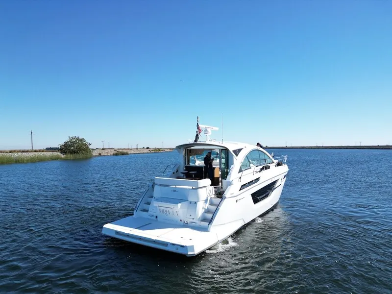 Slide: The Image of A luxurious white yacht cruising on calm water, with a clear blue sky in the background. - 5