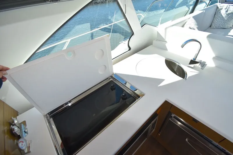 Slide: The Image of The 2019 Cruisers Yachts 50 Cantius kitchen features a stove and sink. - 12