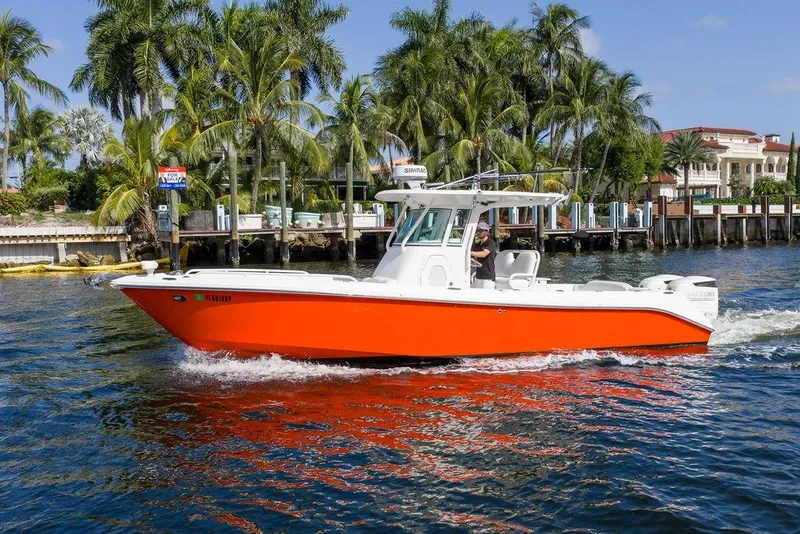 Slide: The Image of 2006 Everglades 290 Center Console boat cruising near palm-lined waterfront homes. - 8