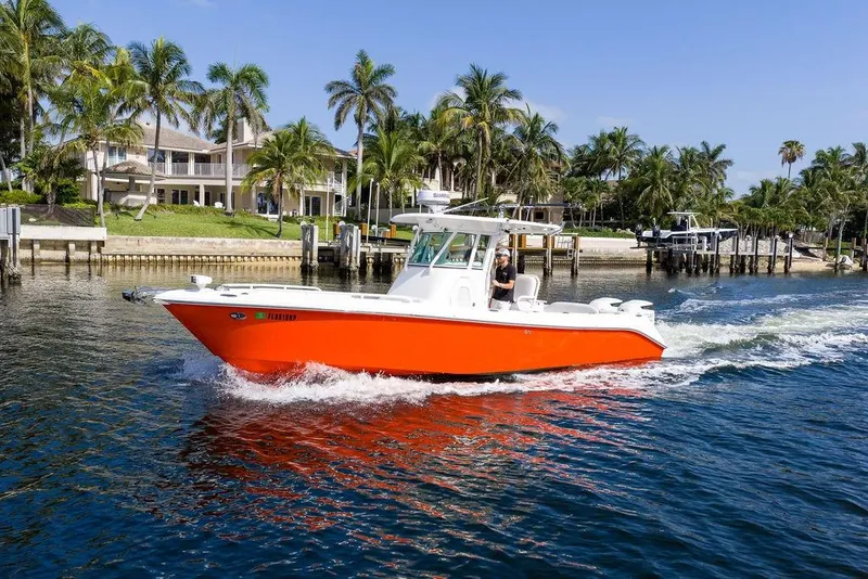 Slide: The Image of 2006 Everglades 290 Center Console boat cruising near waterfront homes and palm trees. - 13