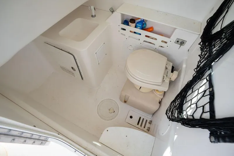 Slide: The Image of 2006 Everglades 290 Center Console boat bathroom with sink and toilet. - 28