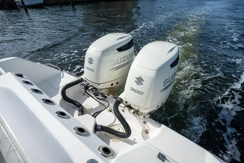 Slide: The Image of Twin Suzuki 300 outboard engines on a 2006 Everglades 290 Center Console boat. - 31