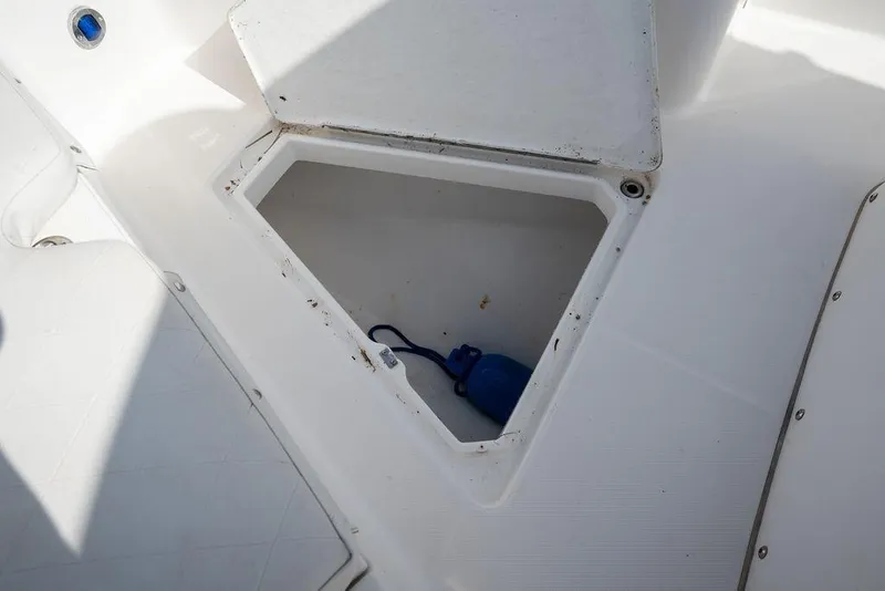 Slide: The Image of Open storage compartment on 2006 Everglades 290 Center Console boat. - 16