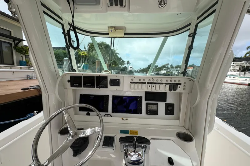 Slide: The Image of 2006 Everglades 290 Center Console boat cockpit with steering wheel and navigation controls. - 23