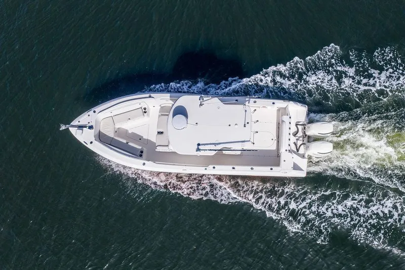 Slide: The Image of Aerial view of 2006 Everglades 290 Center Console boat cruising on water. - 11