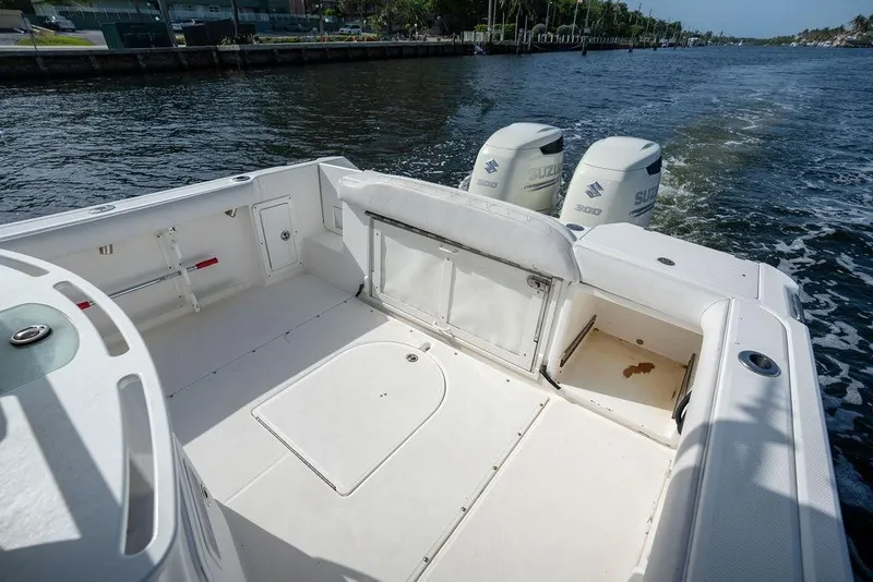 Slide: The Image of 2006 Everglades 290 Center Console boat with dual Suzuki engines on a calm waterway. - 18