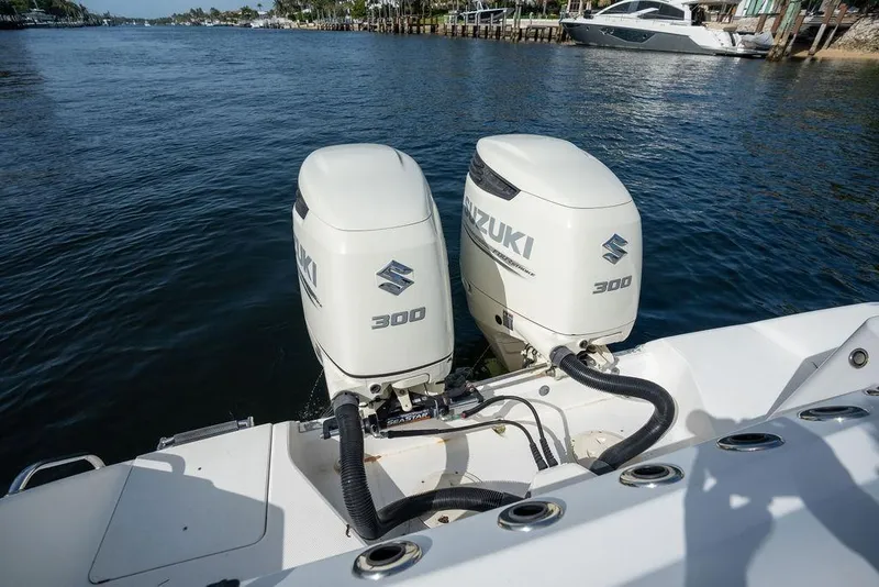 Slide: The Image of Twin Suzuki 300 outboard engines on a 2006 Everglades 290 Center Console boat. - 32
