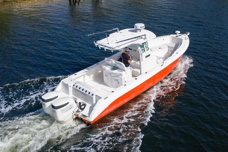 Slide: The Image of 2006 Everglades 290 Center Console boat cruising on water with dual Suzuki engines. - 3