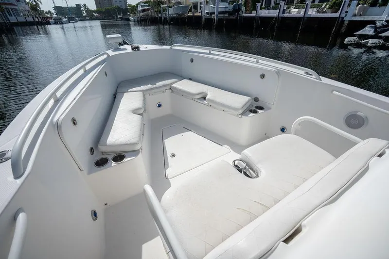 Slide: The Image of 2006 Everglades 290 Center Console boat interior with white seating and cup holders. - 14
