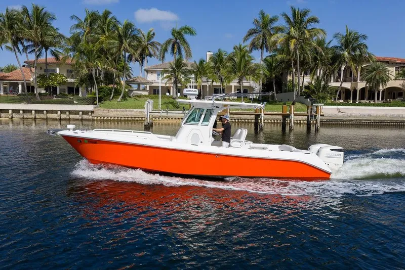 Slide: The Image of 2006 Everglades 290 Center Console boat cruising near waterfront homes with palm trees. - 12