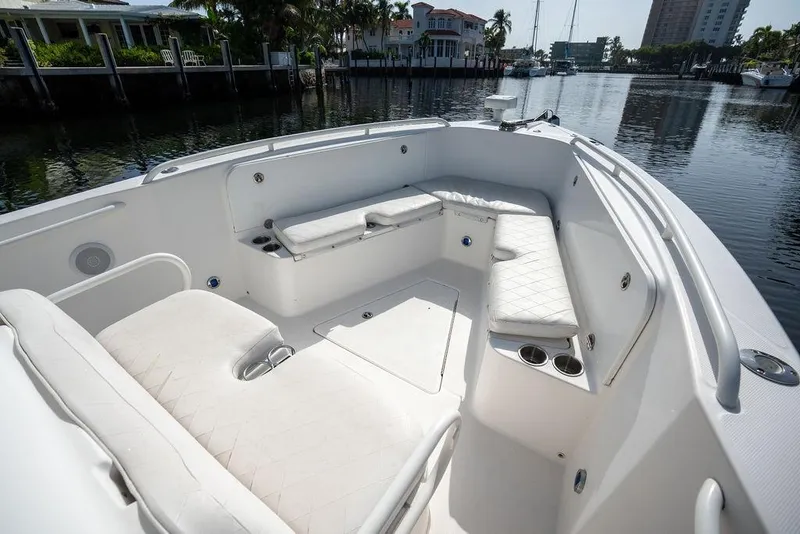 Slide: The Image of 2006 Everglades 290 Center Console boat interior with white seating and cup holders. - 17