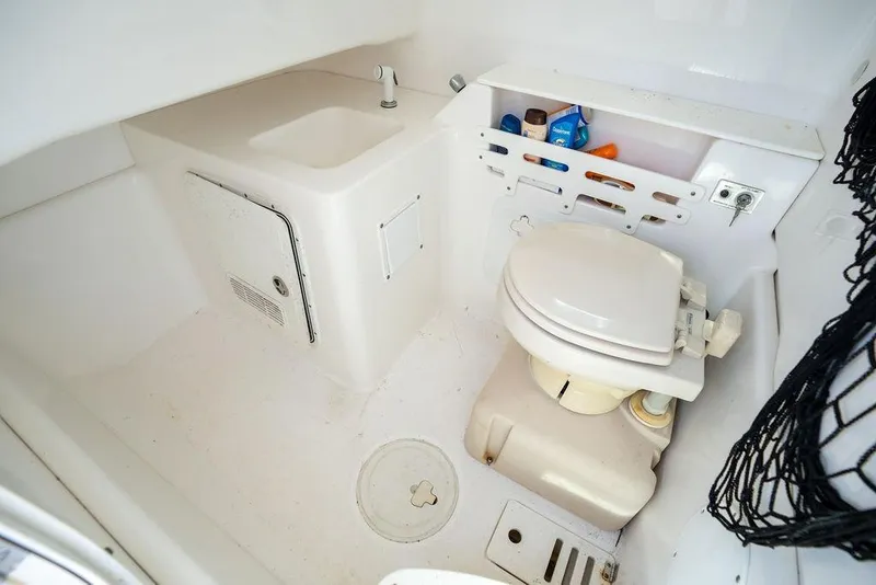 Slide: The Image of 2006 Everglades 290 Center Console boat bathroom with sink and toilet. - 29