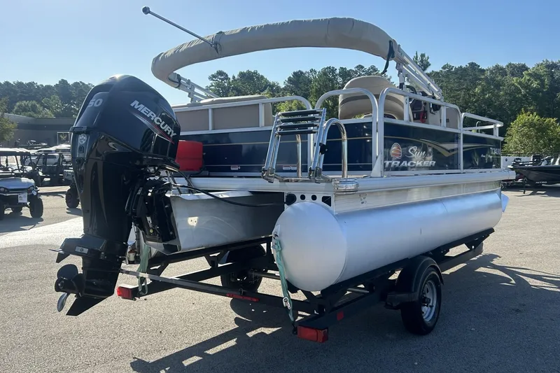 Slide: The Image of 2023 Sun Tracker Bass Buggy 16 XL Select pontoon boat with Mercury engine on trailer. - 5