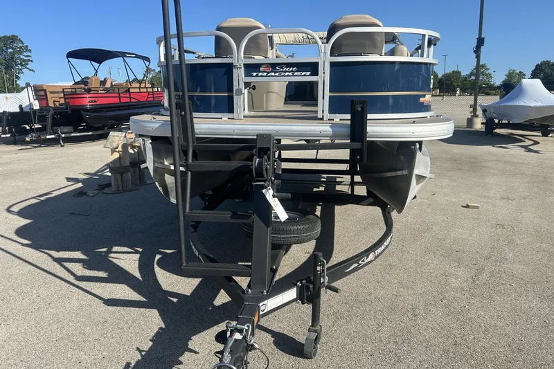 Slide: The Image of 2023 Sun Tracker Bass Buggy 16 XL Select pontoon boat on trailer in outdoor lot. - 13
