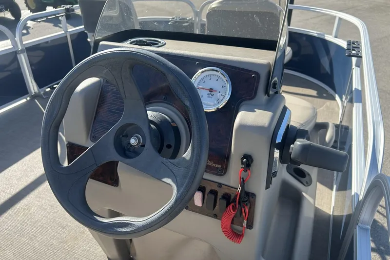 Slide: The Image of 2023 Sun Tracker Bass Buggy 16 XL Select steering console with gauge and controls. - 9