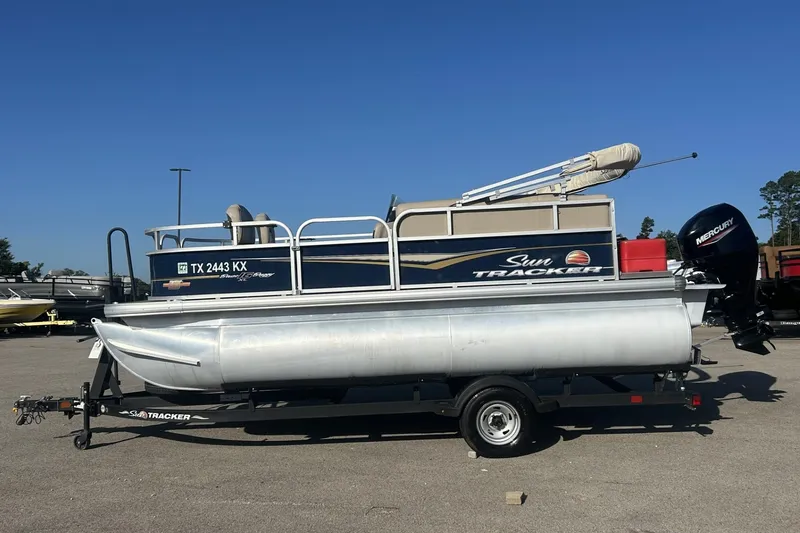 Slide: The Image of 2023 Sun Tracker Bass Buggy 16 XL Select pontoon boat on trailer, side view. - 3