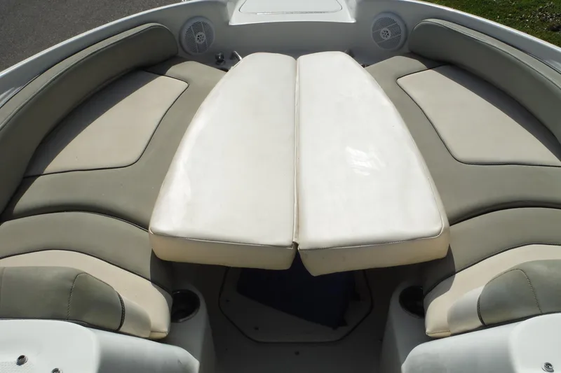 Slide: The Image of 2005 Sea Ray 240 Sundeck boat interior with cushioned seating and speakers. - 22