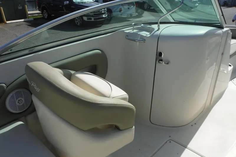 Slide: The Image of Interior view of a 2005 Sea Ray 240 Sundeck boat, featuring seating and dashboard. - 10