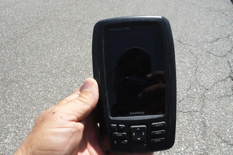 Slide: The Image of Hand holding a Garmin GPS device, suitable for a 2005 Sea Ray 240 Sundeck. - 37