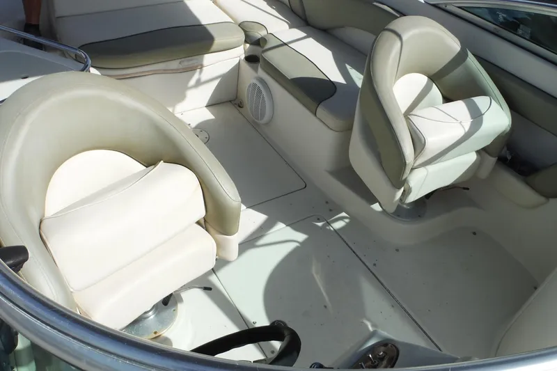 Slide: The Image of Interior seating of 2005 Sea Ray 240 Sundeck boat, featuring cushioned seats and spacious layout. - 32