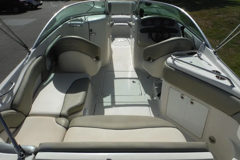 Slide: The Image of 2005 Sea Ray 240 Sundeck interior with seating and helm, showcasing spacious design. - 6