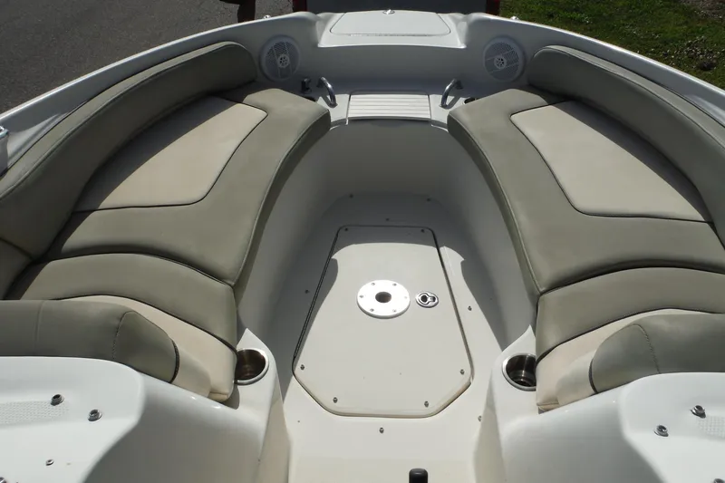 Slide: The Image of 2005 Sea Ray 240 Sundeck interior with cushioned seating and cup holders. - 7