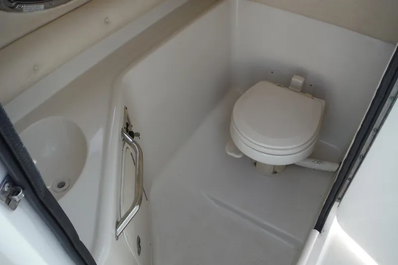 Slide: The Image of 2005 Sea Ray 240 Sundeck boat bathroom with toilet and sink. - 11