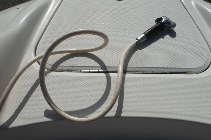 Slide: The Image of Hose on 2005 Sea Ray 240 Sundeck boat deck, coiled and ready for use. - 21