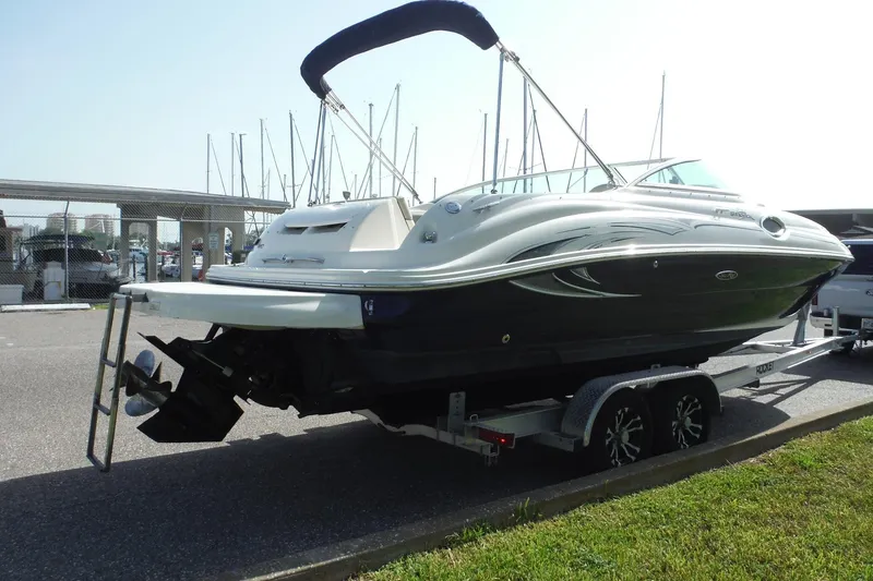 Slide: The Image of 2005 Sea Ray 240 Sundeck boat on trailer, docked at marina. - 4