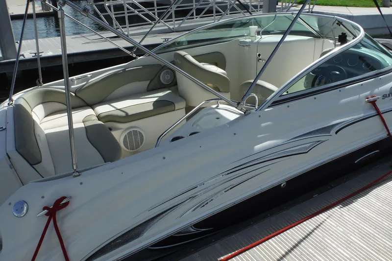 Slide: The Image of 2005 Sea Ray 240 Sundeck boat with spacious seating, docked at a marina. - 30