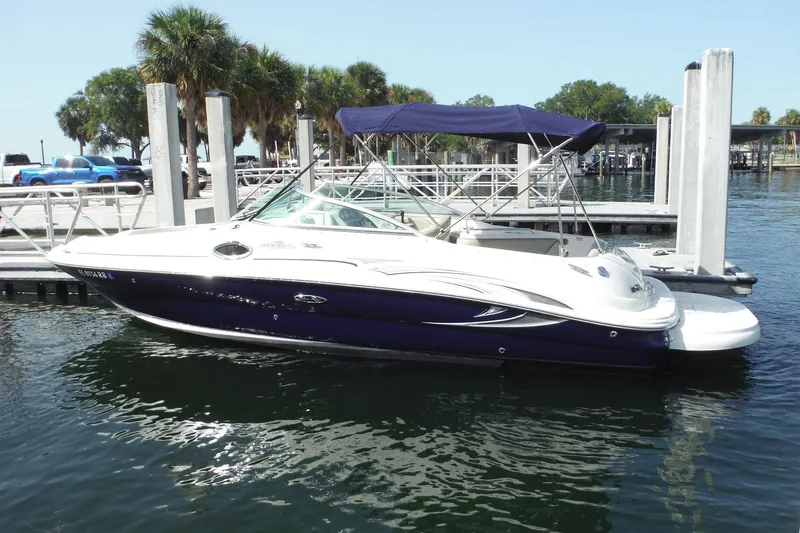 Slide: The Image of 2005 Sea Ray 240 Sundeck boat docked at marina with blue canopy. - 27