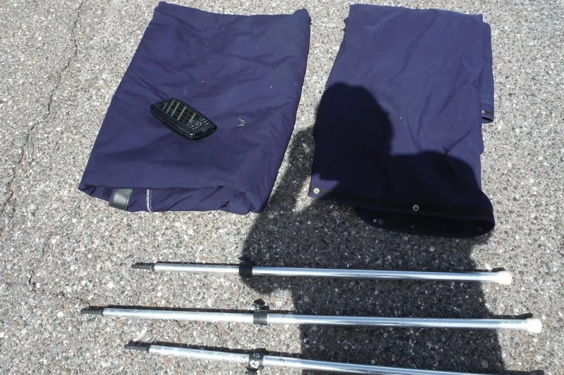 Slide: The Image of Blue boat covers and poles for 2005 Sea Ray 240 Sundeck on pavement. - 34