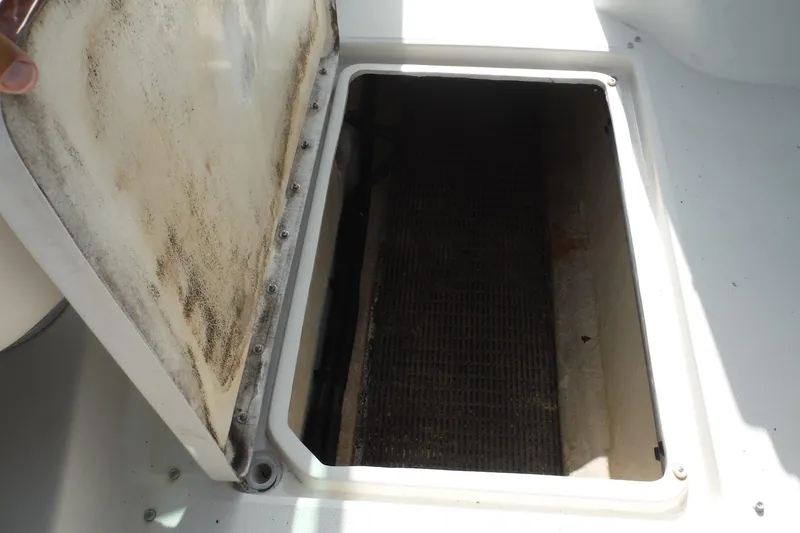 Slide: The Image of Open storage compartment on a 2005 Sea Ray 240 Sundeck boat. - 19