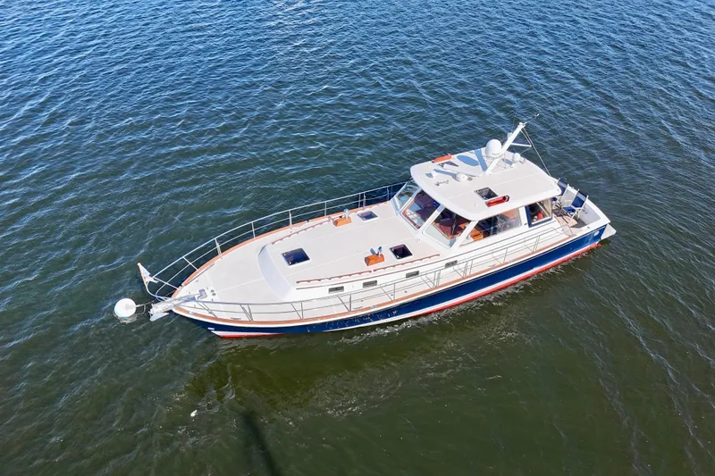 Slide: The Image of 2001 Grand Banks 49 Eastbay HX yacht cruising on open water. - 11
