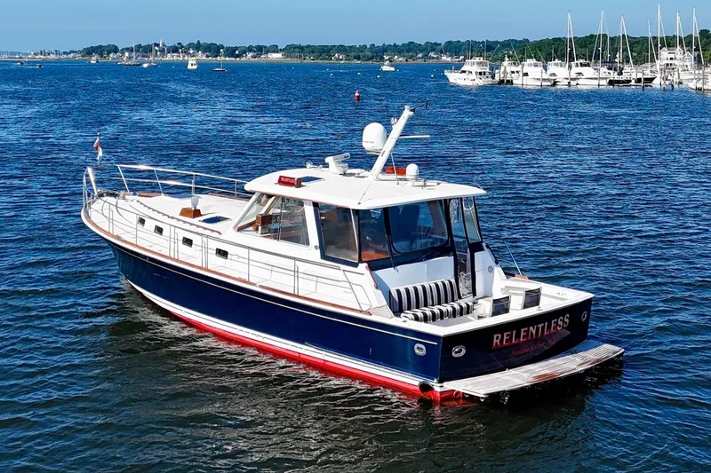 Slide: The Image of 2001 Grand Banks 49 Eastbay HX yacht cruising in a scenic marina setting. - 4