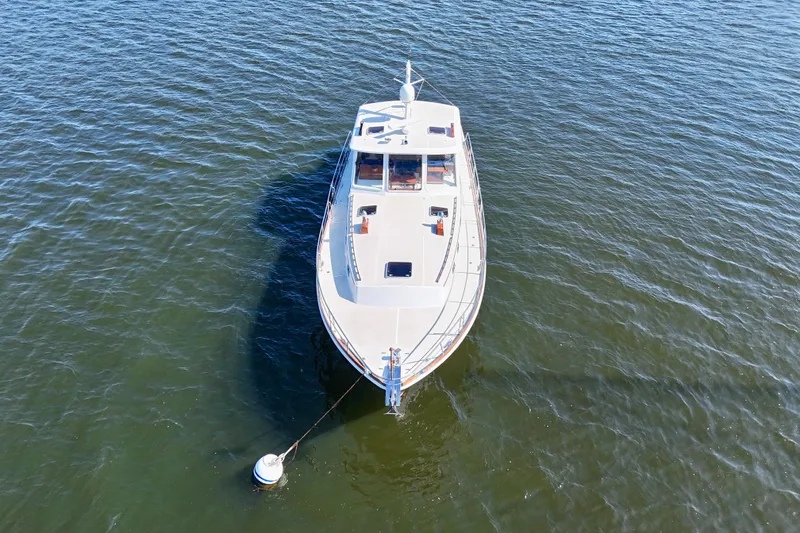 Slide: The Image of Aerial view of 2001 Grand Banks 49 Eastbay HX yacht anchored on calm water. - 10